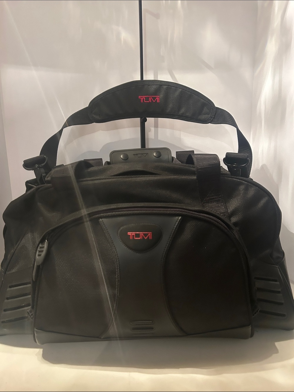 Tumi Black Duffel Bag with Red Logo Accent